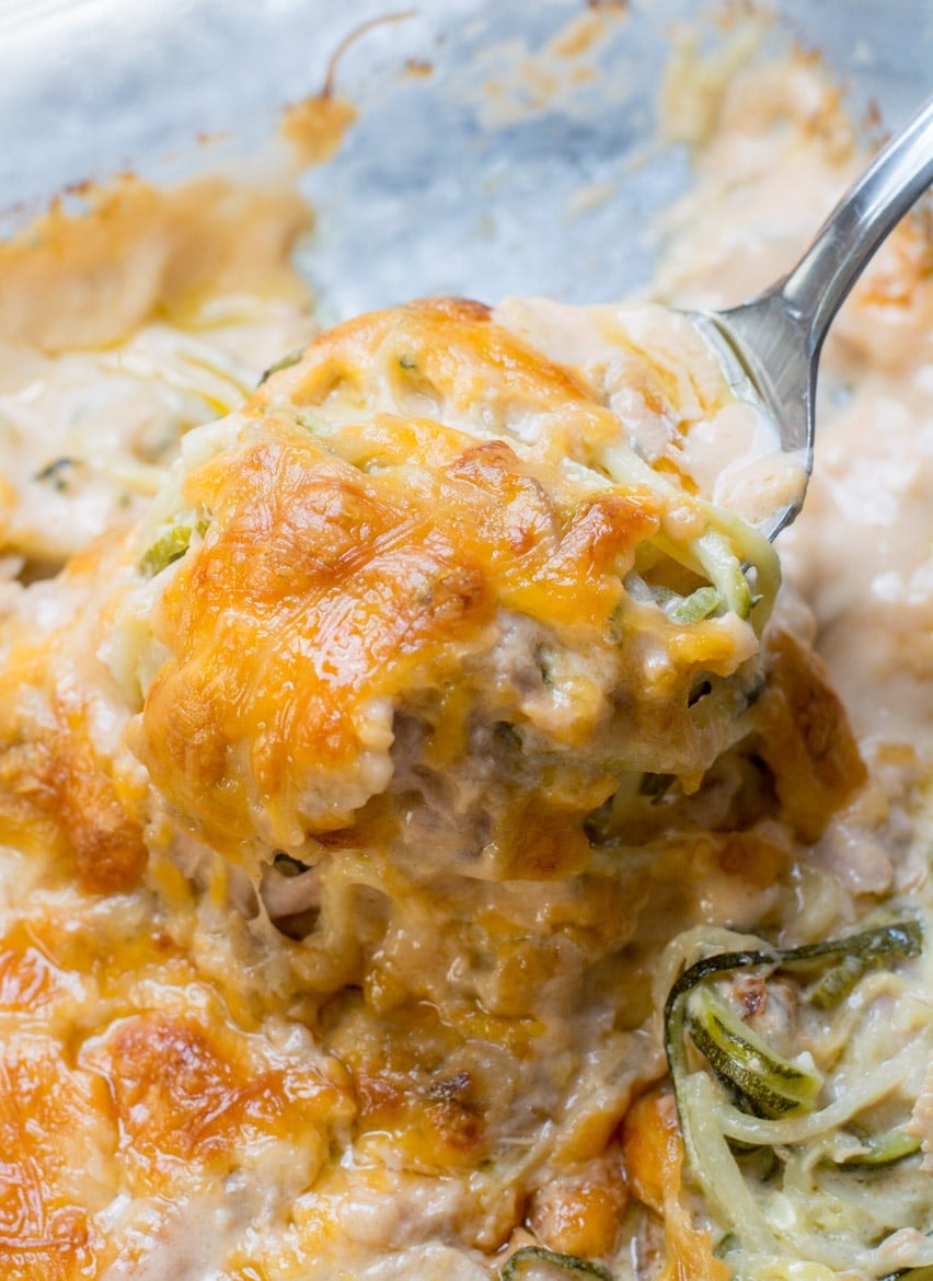A serving of keto tuna casserole being scooped from a baking dish. 