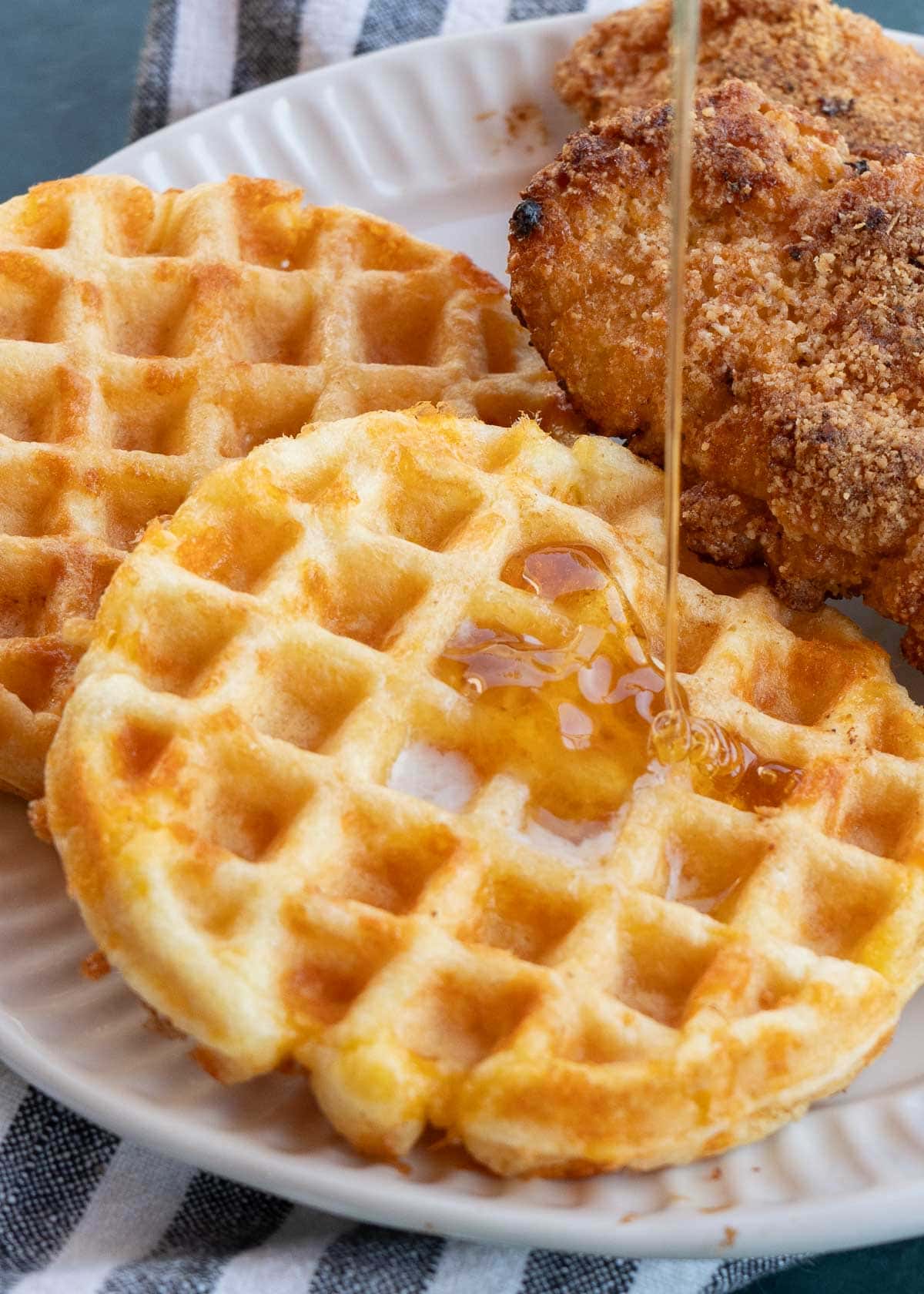 chaffles with syrup and fried chicken on a plate