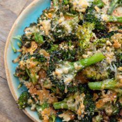 pile of cheesy smashed broccoli with parmesan on a plate