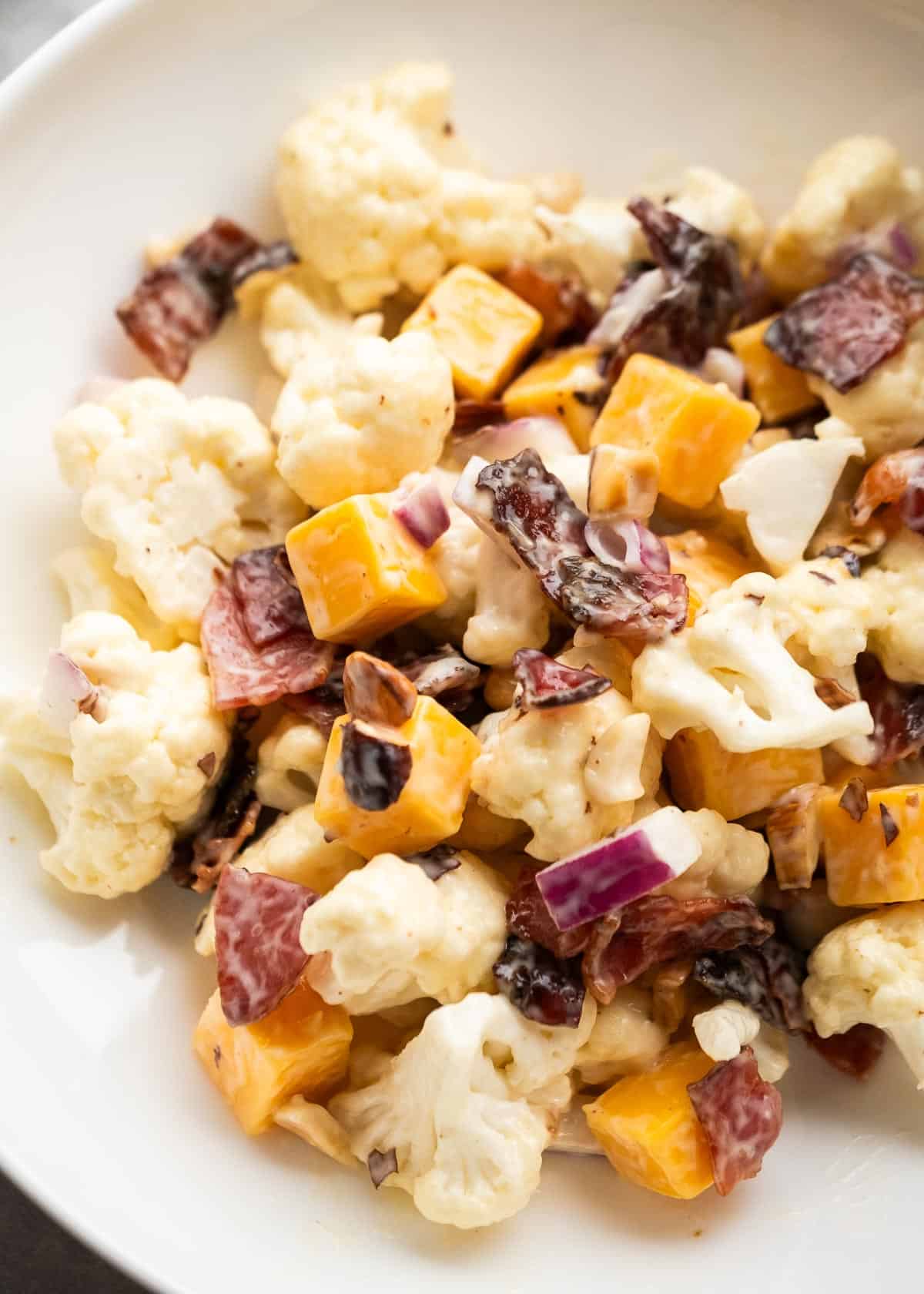 close up image of cauliflower salad in white bowl
